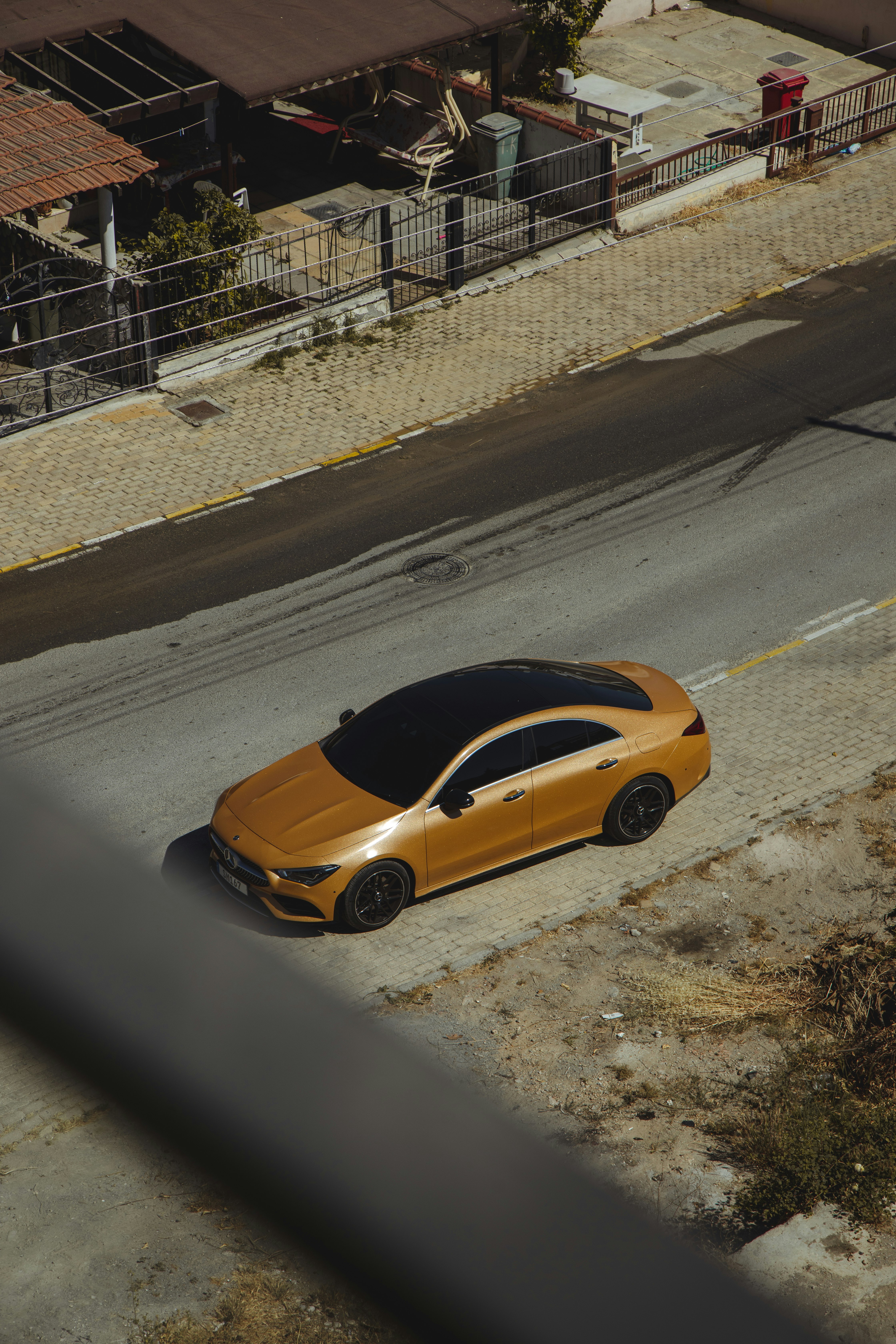 yellow car on gray asphalt road during daytime